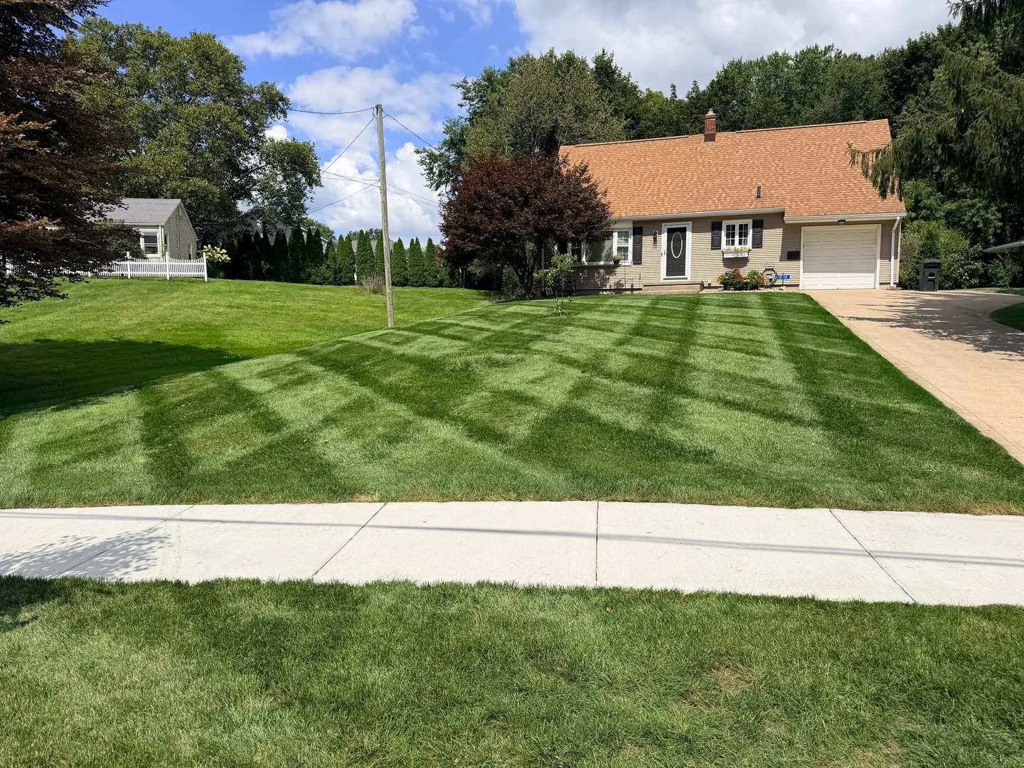 Striped lawn maintained by City Mowing