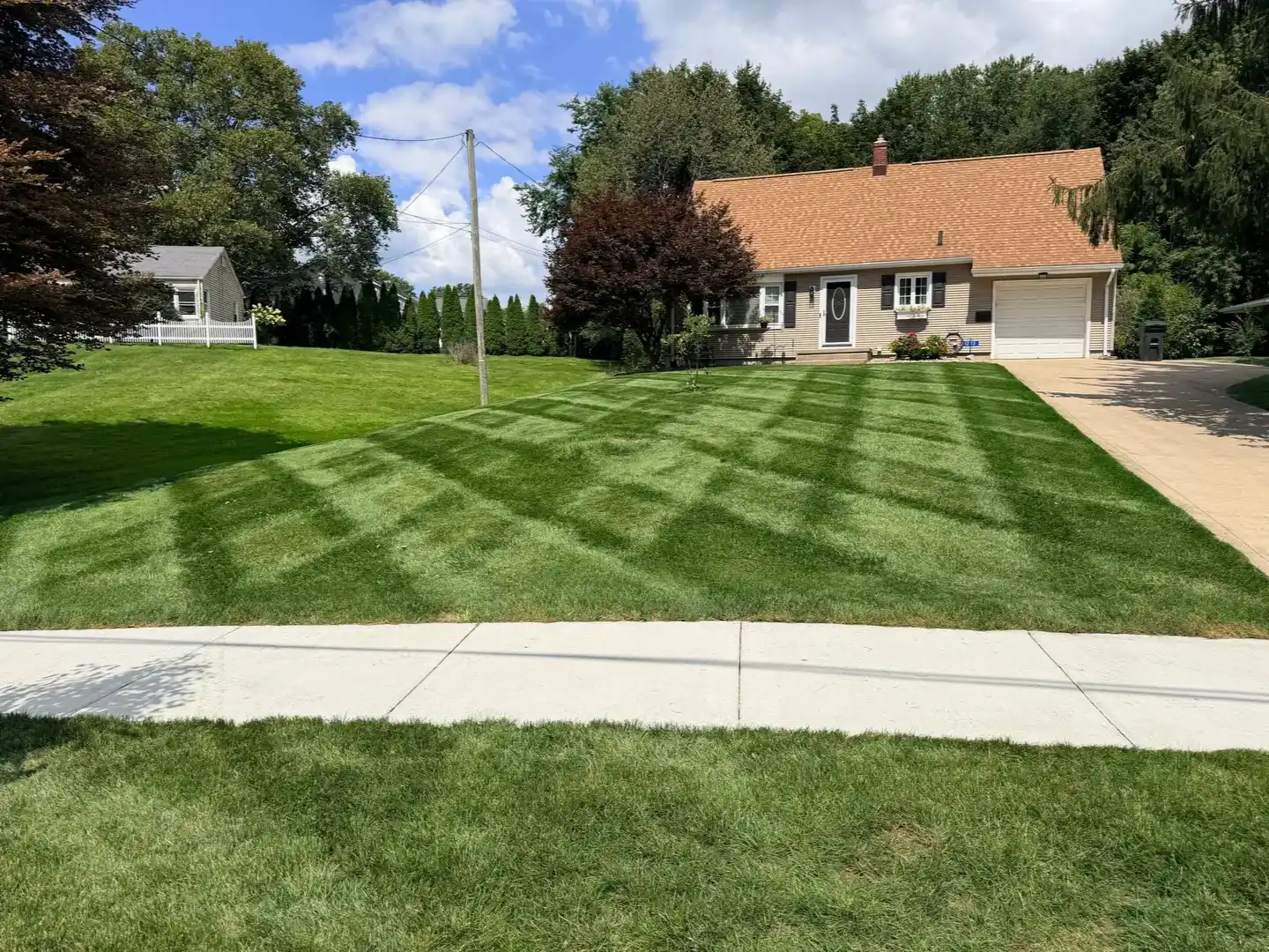 Striped lawn maintained by City Mowing