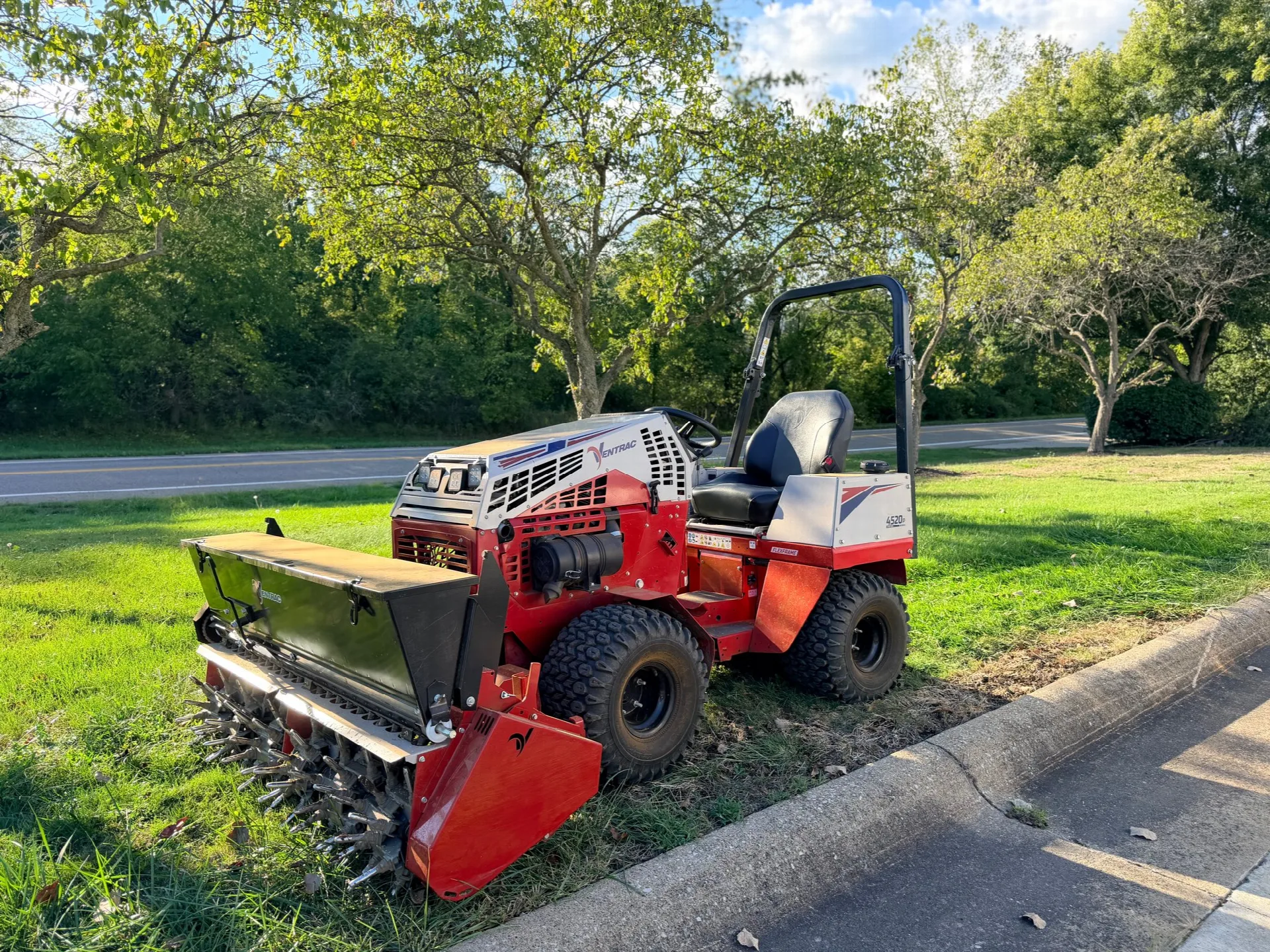 City Mowing aeration and overseeding equipment on a lawn